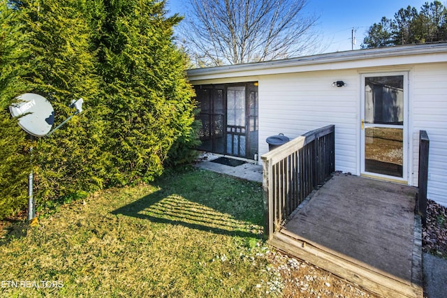 property entrance featuring a lawn