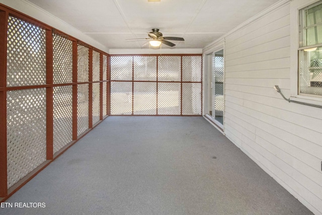 unfurnished sunroom with ceiling fan