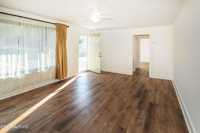 empty room featuring dark wood-type flooring and ceiling fan