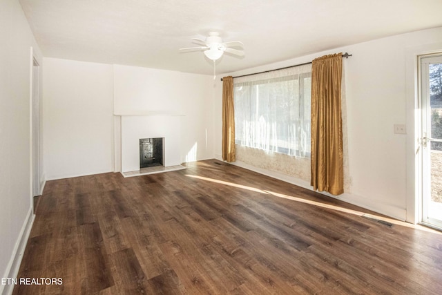 unfurnished living room featuring dark hardwood / wood-style floors and ceiling fan