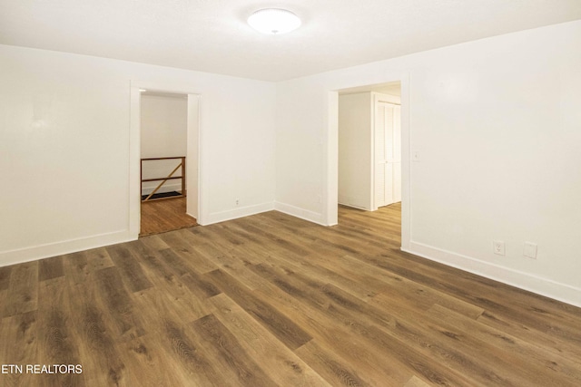 spare room featuring dark wood-type flooring