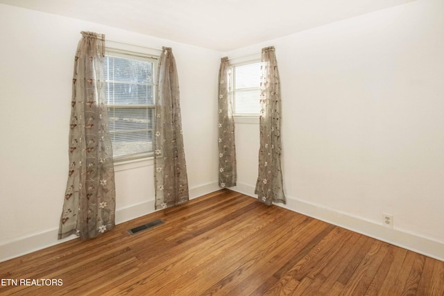 empty room with hardwood / wood-style flooring