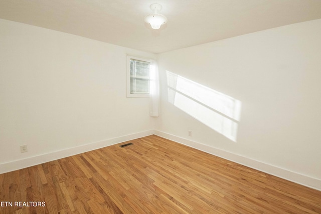 spare room with hardwood / wood-style floors