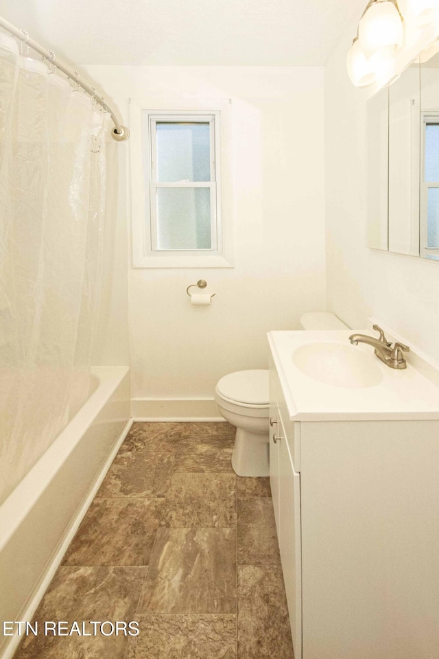 full bathroom with vanity, shower / tub combo, and toilet