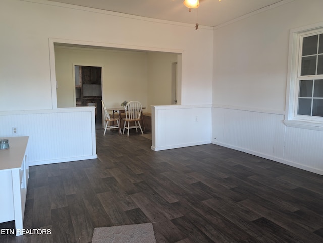 unfurnished room with dark wood-type flooring and crown molding