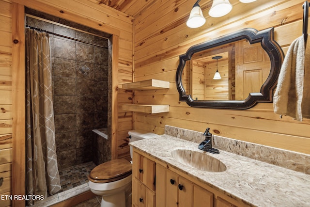 bathroom with toilet, vanity, wooden walls, and a shower with shower curtain