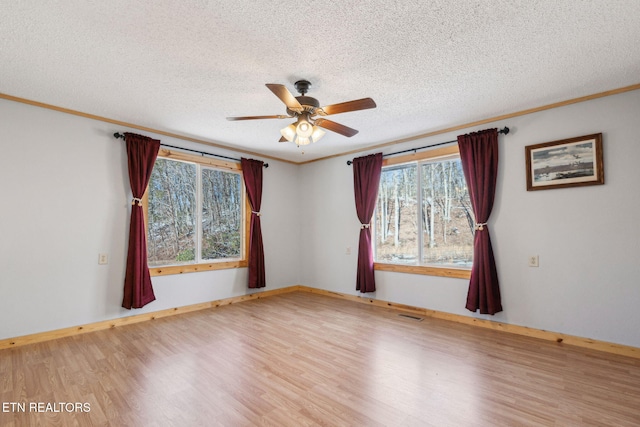 spare room with ceiling fan, crown molding, light hardwood / wood-style flooring, and a textured ceiling