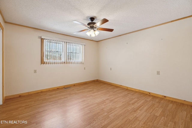 empty room with a textured ceiling, light hardwood / wood-style flooring, and ceiling fan