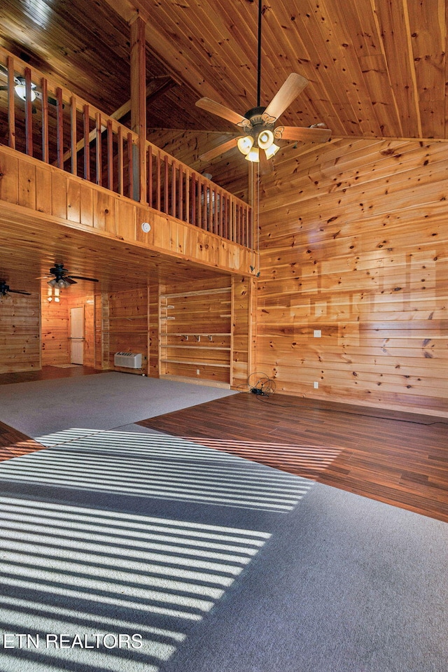 spare room featuring high vaulted ceiling, carpet floors, wooden ceiling, and ceiling fan