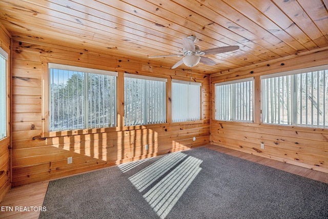 unfurnished sunroom with ceiling fan and wood ceiling