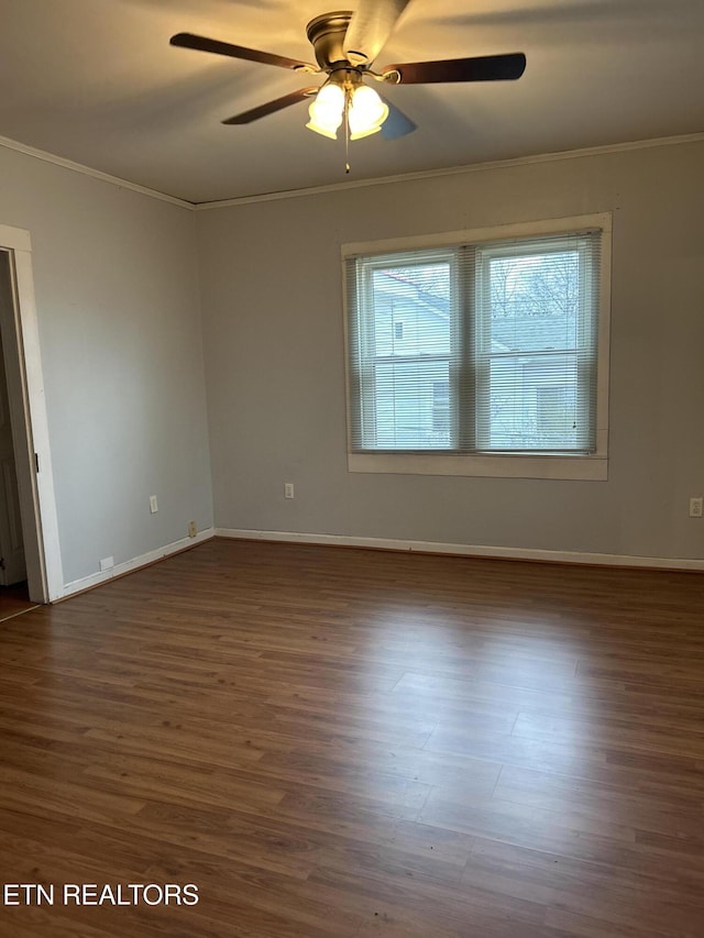 spare room featuring ceiling fan, ornamental molding, and dark hardwood / wood-style flooring