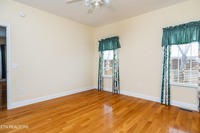 spare room with wood-type flooring and ceiling fan