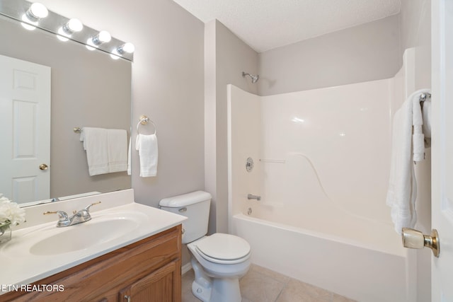 full bathroom featuring tile patterned floors, toilet,  shower combination, a textured ceiling, and vanity