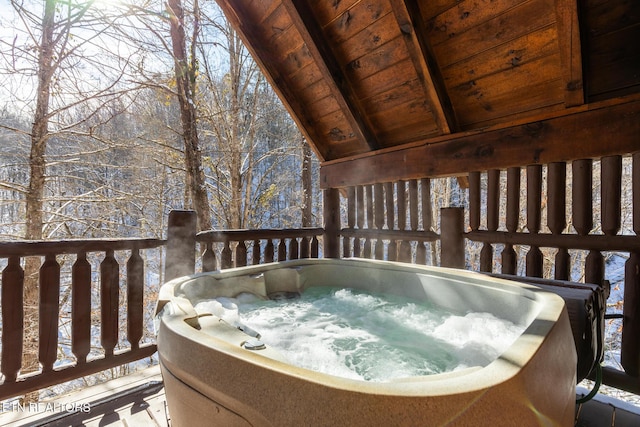 snow covered deck with a hot tub