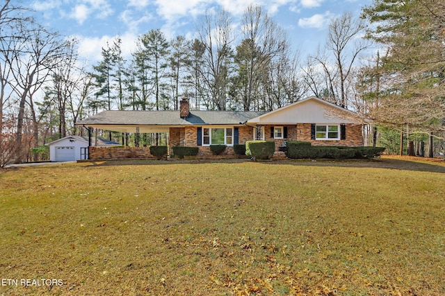 ranch-style home with a garage, an outdoor structure, and a front yard