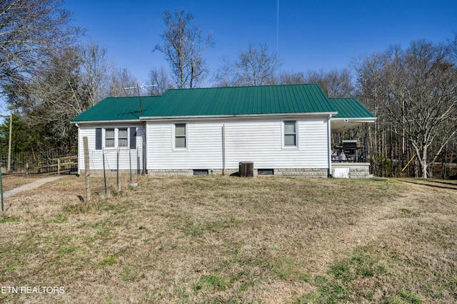 back of house featuring a yard and cooling unit