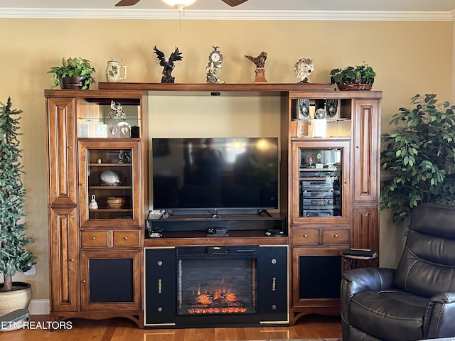 living room featuring ornamental molding, wood-type flooring, and ceiling fan