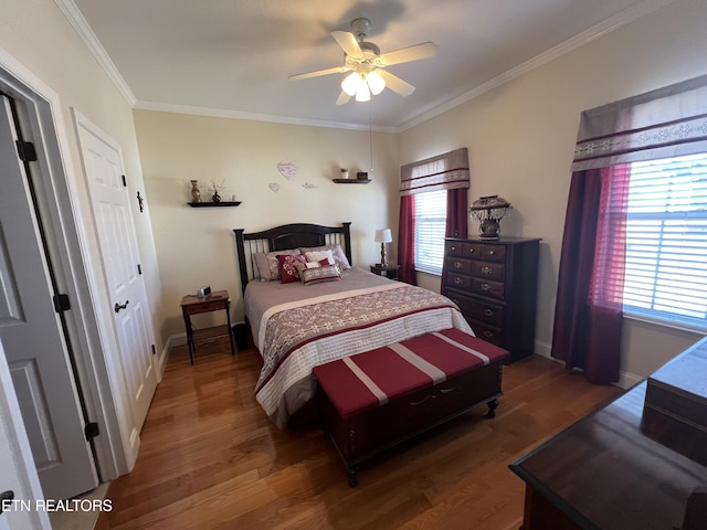 bedroom featuring crown molding, dark hardwood / wood-style floors, and ceiling fan