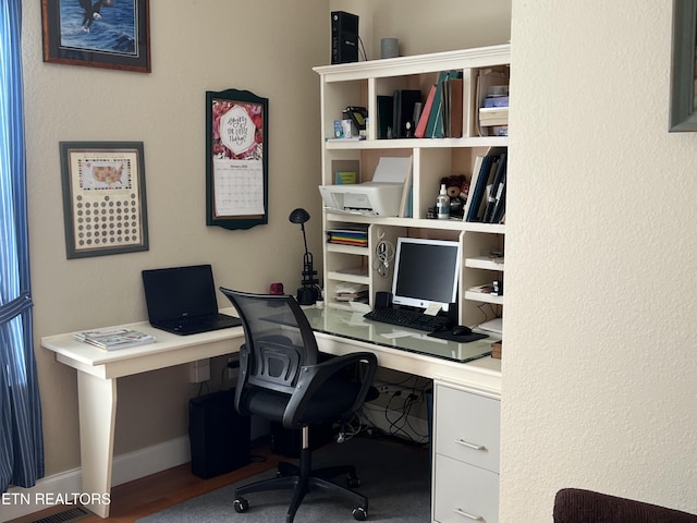 home office with wood-type flooring