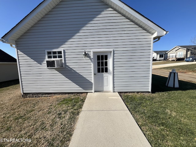 back of property with cooling unit and a lawn