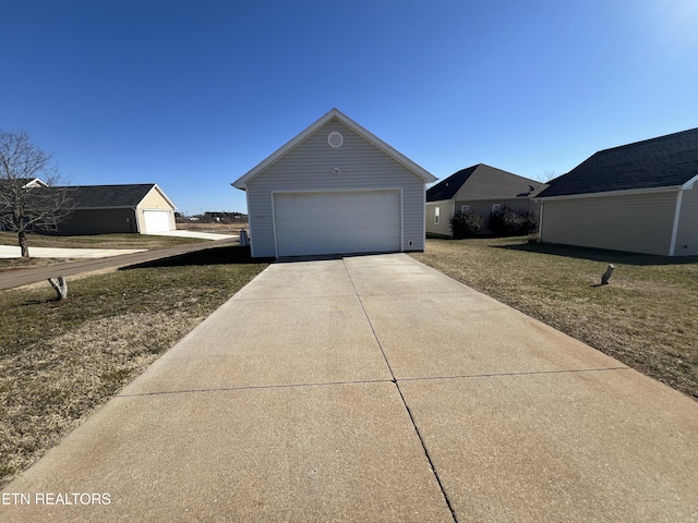 view of home's exterior with a garage, an outdoor structure, and a lawn