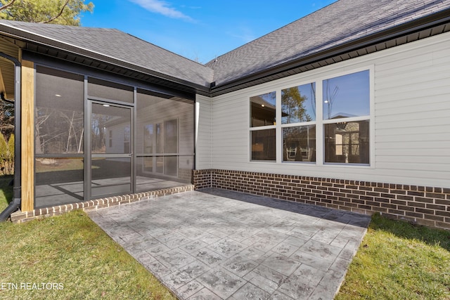 view of patio featuring a sunroom