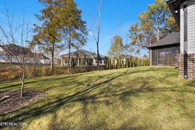 view of yard featuring a sunroom