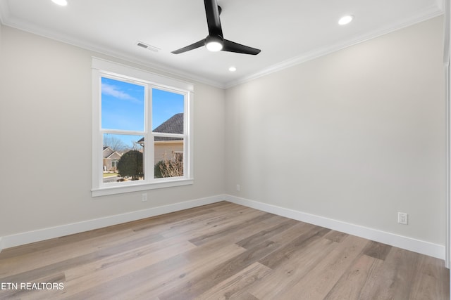 empty room featuring baseboards, ornamental molding, and light wood-style flooring