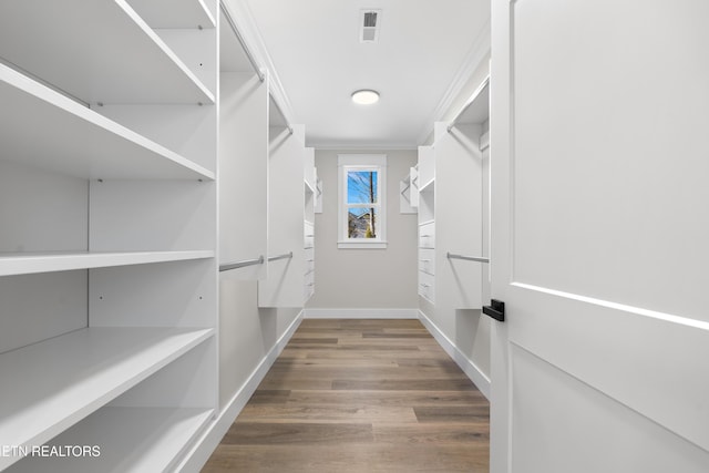 spacious closet with visible vents and wood finished floors