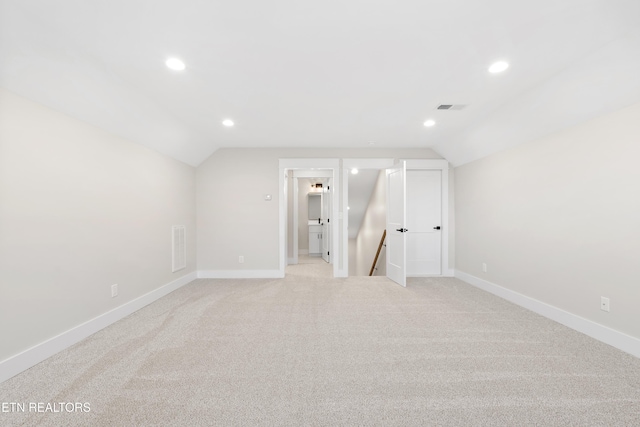 additional living space featuring vaulted ceiling, visible vents, and baseboards