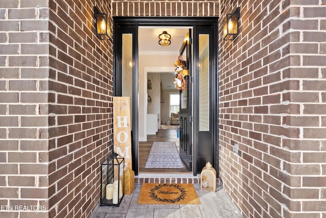 property entrance featuring brick siding