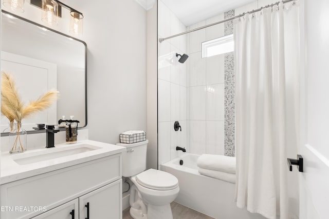 full bathroom with shower / tub combo with curtain, vanity, and toilet