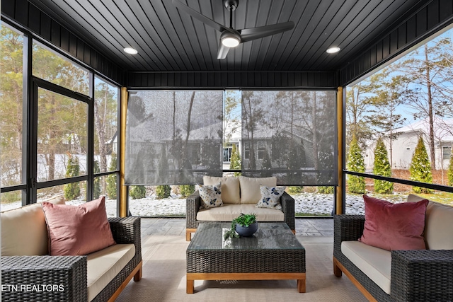 sunroom with wooden ceiling and ceiling fan