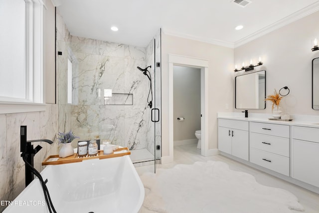 full bathroom featuring a marble finish shower, visible vents, ornamental molding, a freestanding bath, and vanity