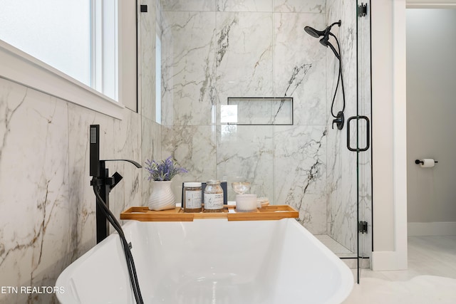 bathroom featuring a freestanding tub and a stall shower