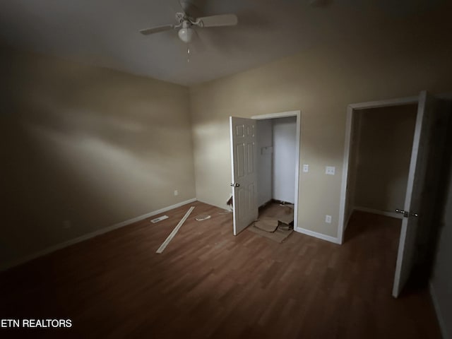 unfurnished bedroom featuring ceiling fan, dark hardwood / wood-style floors, and a closet