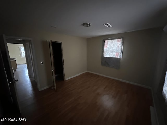 unfurnished room with dark hardwood / wood-style floors