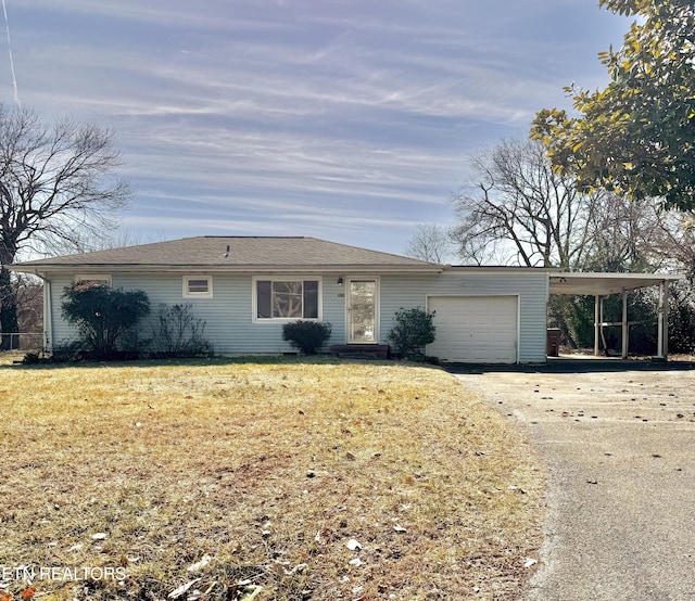 ranch-style house with a carport, a garage, and a front yard