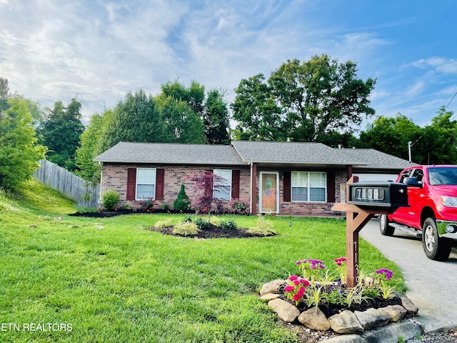 single story home featuring a front lawn