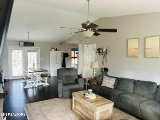 living room with lofted ceiling, wood-type flooring, and ceiling fan