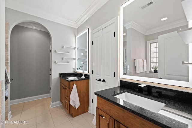 bathroom featuring vanity, tile patterned flooring, and ornamental molding