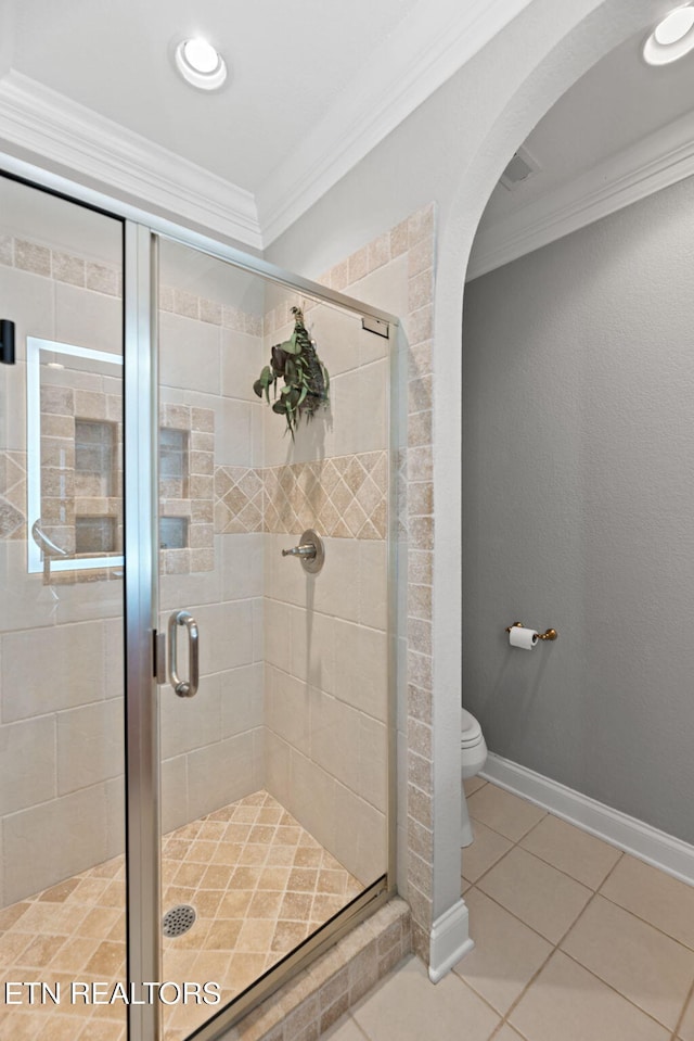 bathroom featuring walk in shower, ornamental molding, toilet, and tile patterned flooring