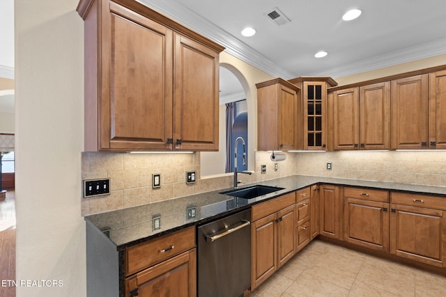 kitchen with visible vents, glass insert cabinets, brown cabinets, stainless steel dishwasher, and a sink