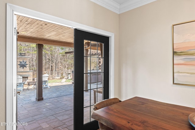 interior space featuring crown molding and brick floor