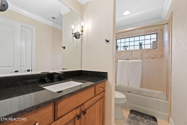 full bathroom featuring tiled shower / bath combo, ornamental molding, vanity, toilet, and tile patterned floors