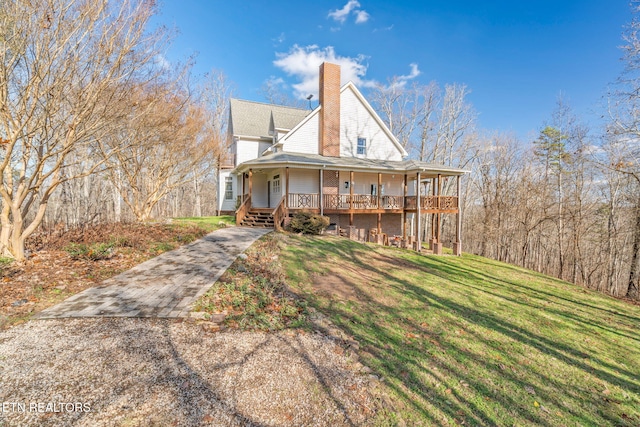 back of property featuring a porch and a lawn