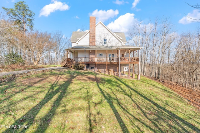 back of house with a lawn