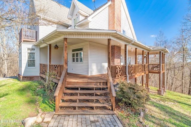 back of house with a yard and covered porch