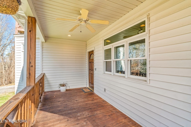 wooden deck featuring ceiling fan