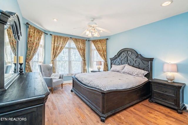 bedroom featuring ceiling fan and light hardwood / wood-style flooring